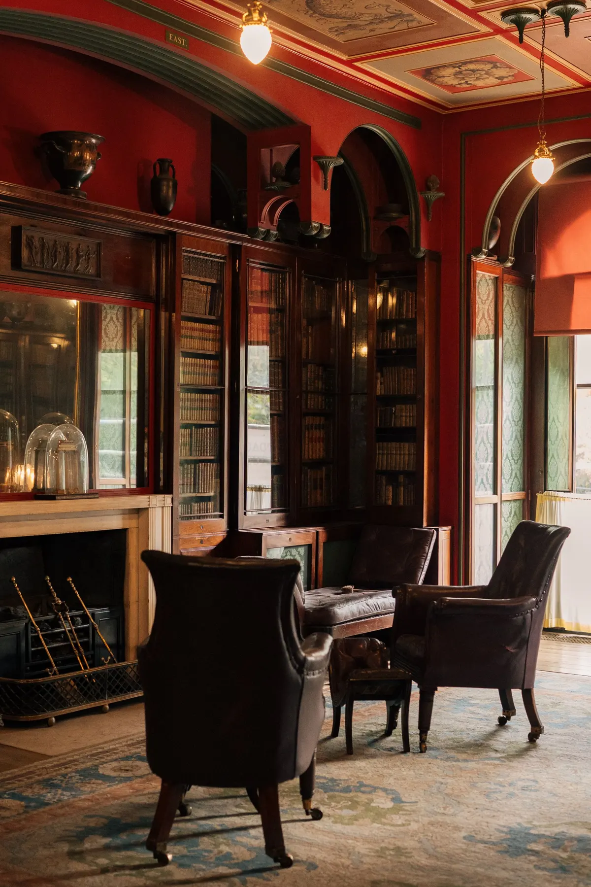 An empty historic London library with bookshelves and leather reading chairs